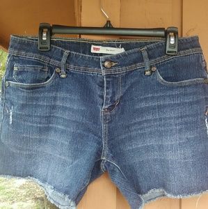 Slightly distressed Levi denim midi cutoff shorts